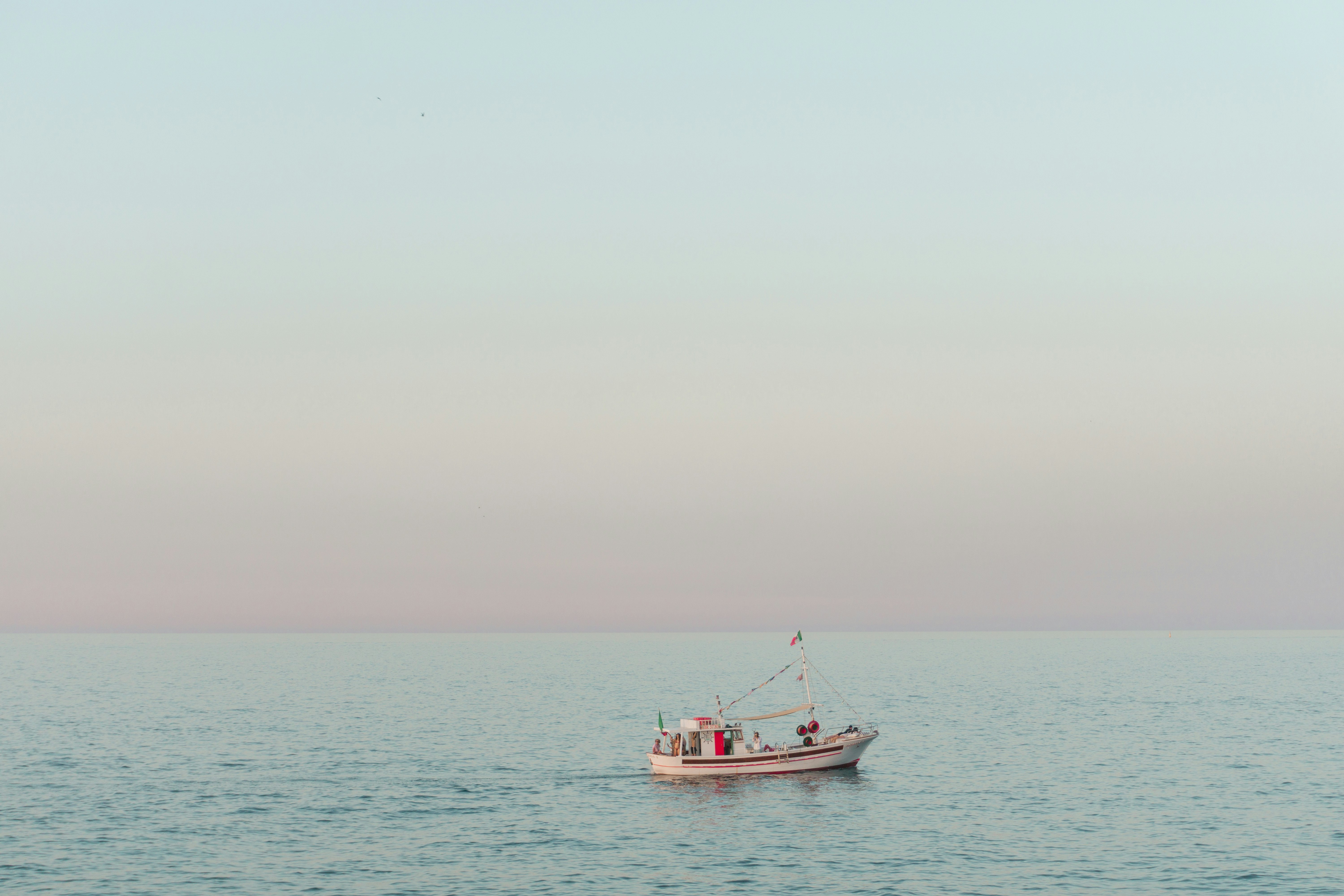 red and white boat on sea during daytime